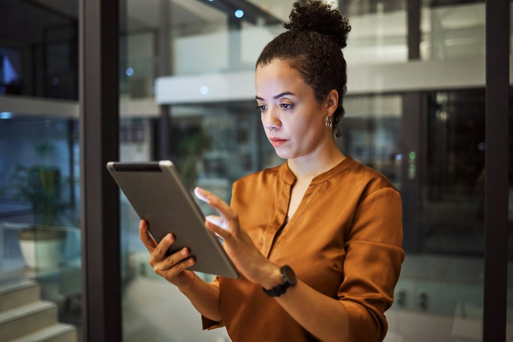 Tablet, night and research with a business woman working late on the internet while on the search f